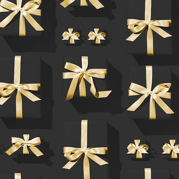 Dark gift boxes tied with gold ribbons