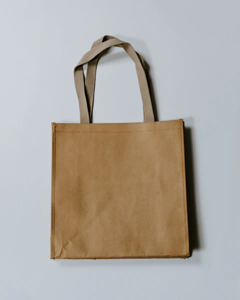 Brown canvas tote bag hanging on a wall